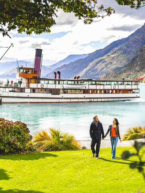 TSS Earnslaw cruising on Lake Wakatipu with mountains in Queenstown, New Zealand.