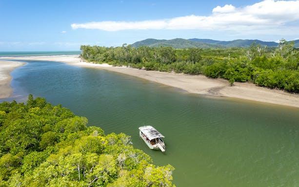 Boat on river in Daintree Rainforest, Cape Tribulation, part of the Ultimate Daintree Tour.