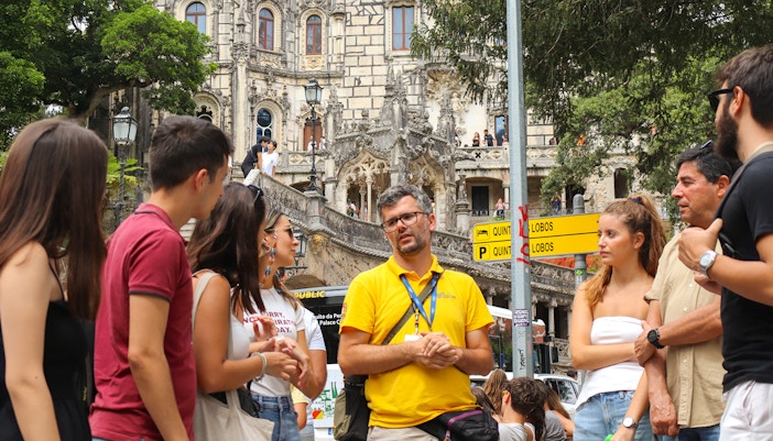 Small group exploring Quinta de Regaleira's intricate architecture in Sintra, Portugal.