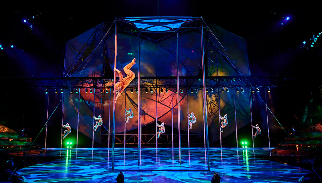Acrobats performing on poles during Mystère show in Las Vegas.