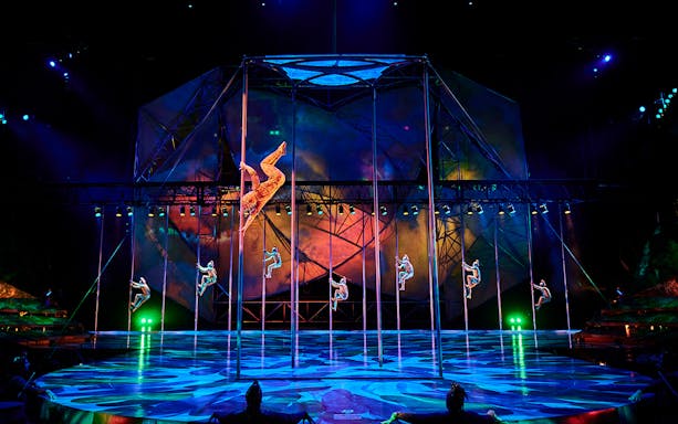 Acrobats performing on poles during Mystère show in Las Vegas.