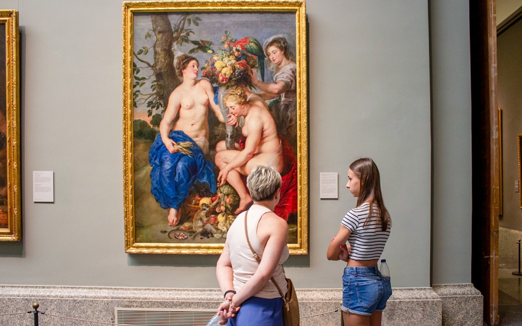 Visitors viewing a painting at Prado Museum, part of the "Skip The Line" Royal Palace + Prado Museum tour.