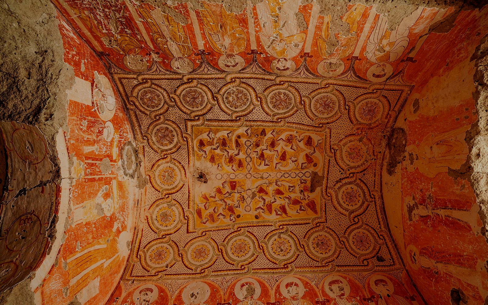 Old church ceiling decorations in Derinkuyu Underground City, featuring intricate patterns and faded frescoes.