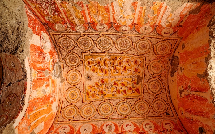 Old church ceiling decorations in Derinkuyu Underground City, featuring intricate patterns and faded frescoes.