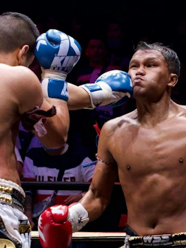 Fighter delivering a punch at SRC SIAM REAL COMBAT, World Siam Stadium, Bangkok.