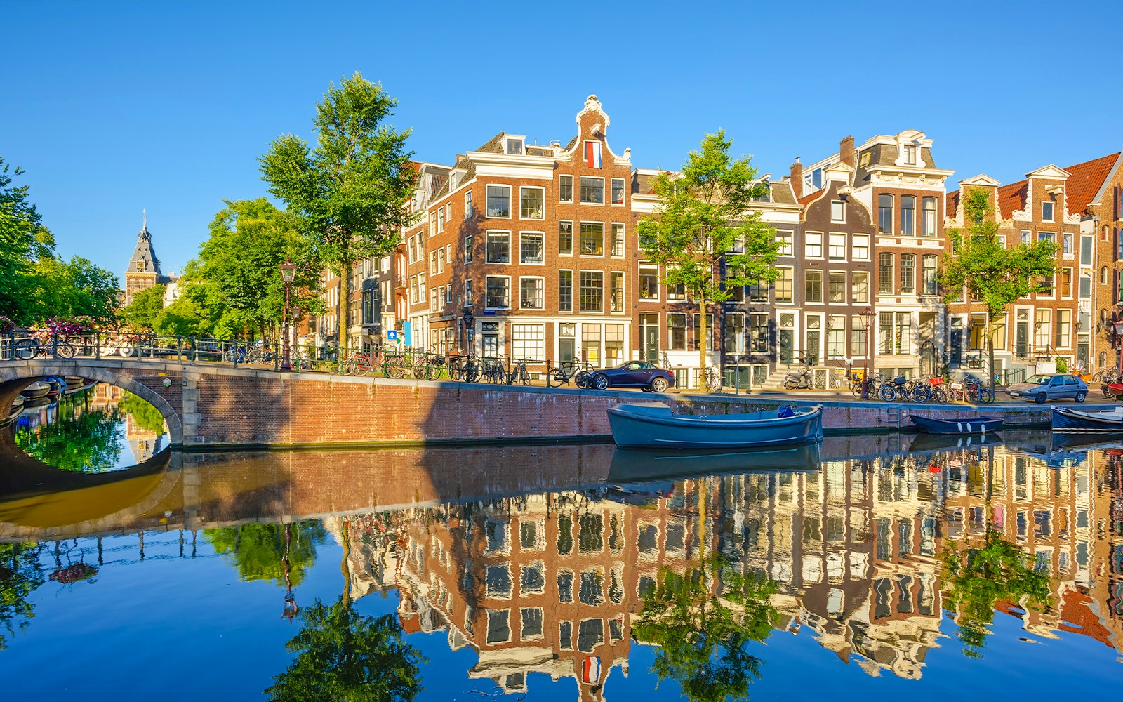 Prinsengracht canal with historic buildings and boats in Amsterdam city.