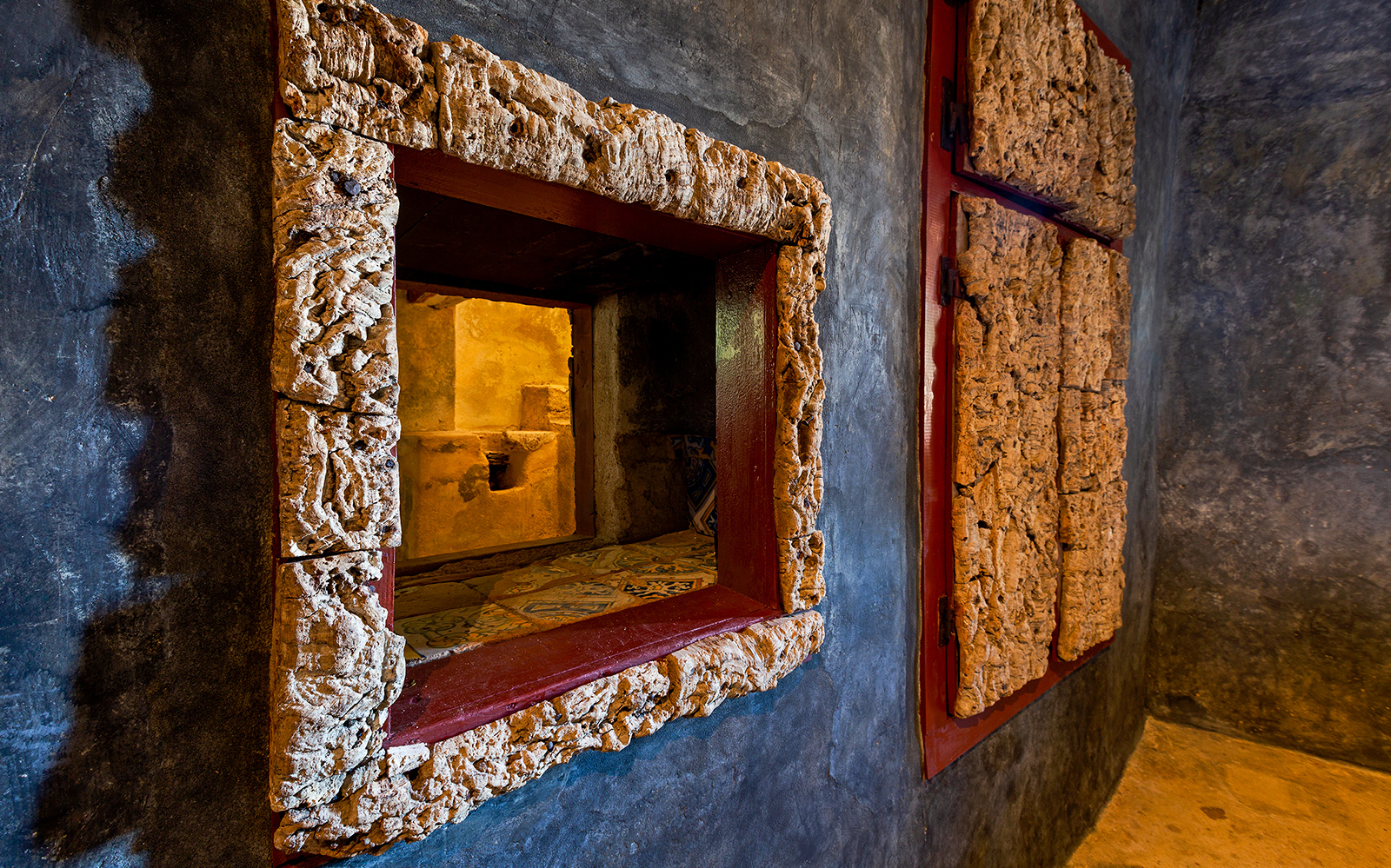 Convento dos Capuchos stone archway surrounded by lush greenery in Sintra, Portugal.