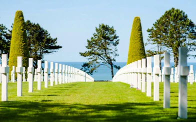Rows of white crosses at Normandy American Cemetery, Colleville-sur-Mer, overlooking the sea.