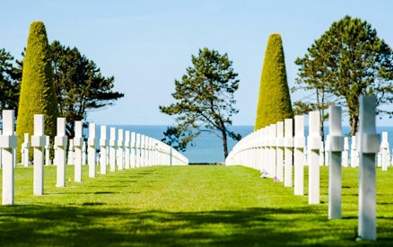 Rows of white crosses at Normandy American Cemetery, Colleville-sur-Mer, overlooking the sea.