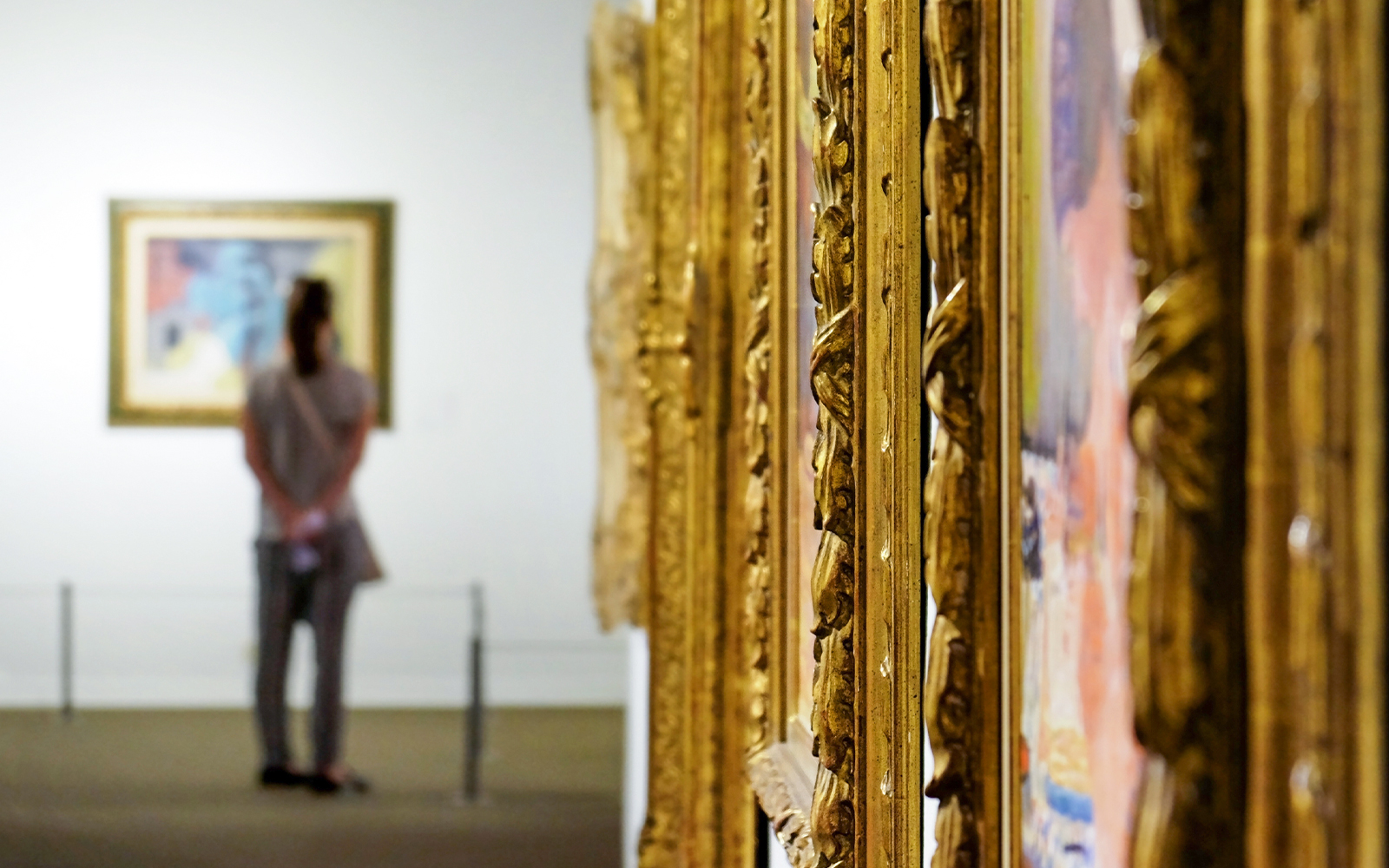 Visitor in museum viewing a painting in in Accademia Gallery