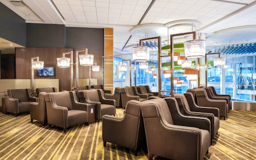 Seating area in Plaza Premium Lounge, Vancouver International Airport, with modern decor and lighting.