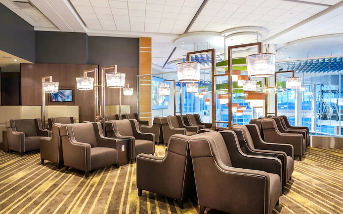 Seating area in Plaza Premium Lounge, Vancouver International Airport, with modern decor and lighting.