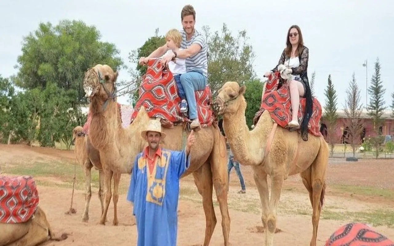 Camel ride experience near Marrakesh with tourists and guide.
