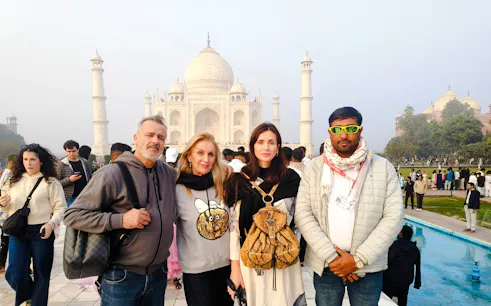 Tourists at the Taj Mahal in Agra during a guided tour from Delhi.