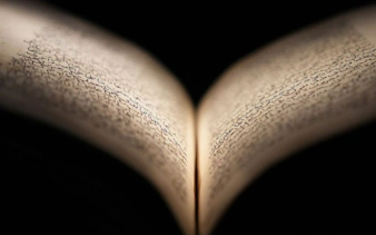 Open book with Arabic script at Light & Peace Museum, Sheikh Zayed Grand Mosque Centre.