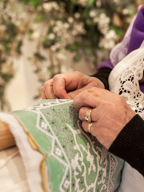 Lady embroidering lace on Burano, Venice tour.
