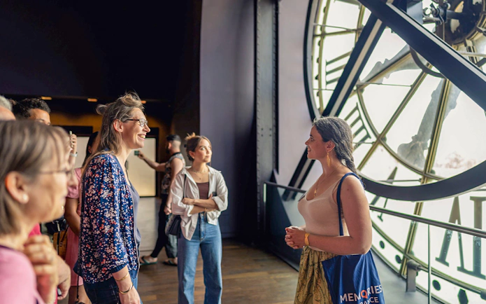 Visitors inside Musée d’Orsay near the clock, Paris tour.