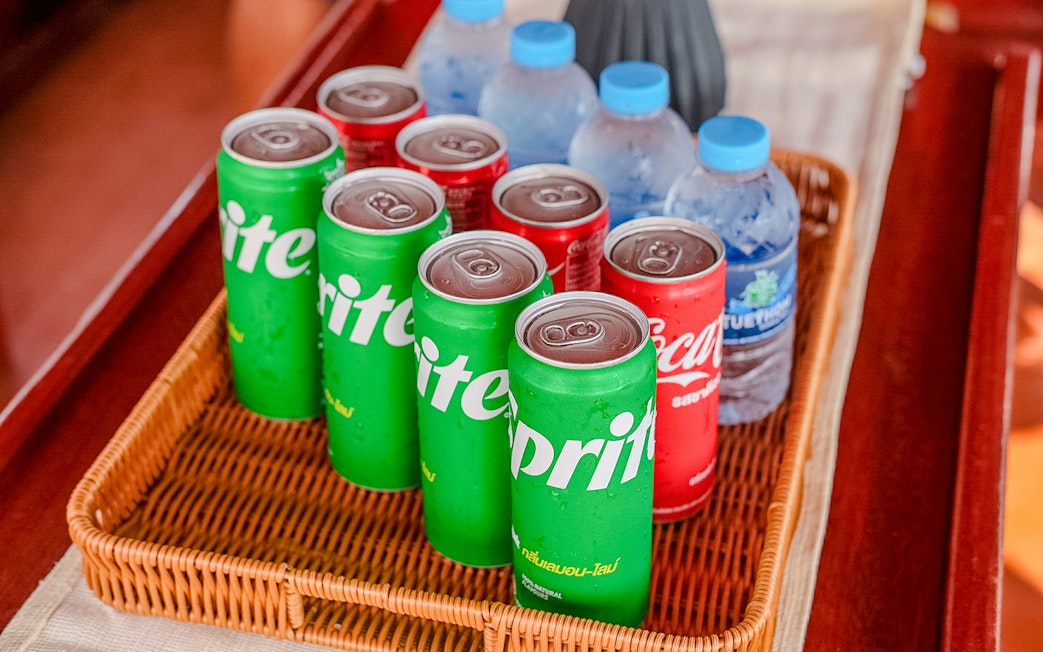 Soft drinks and water bottles in a basket on a tour boat.