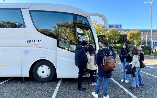 Passengers boarding a bus at Tirana Airport for transfer to Tirana Central.
