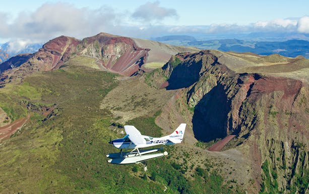 Floatplane flying over Mt Tarawera's rugged landscape during a guided tour from Rotorua.