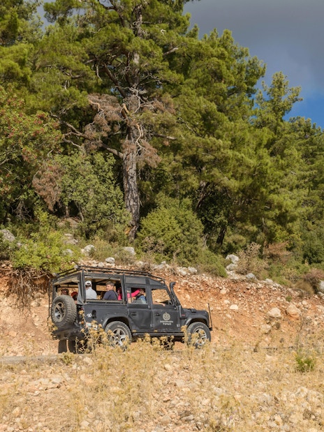 Jeep driving through forested terrain on Antalya safari tour.
