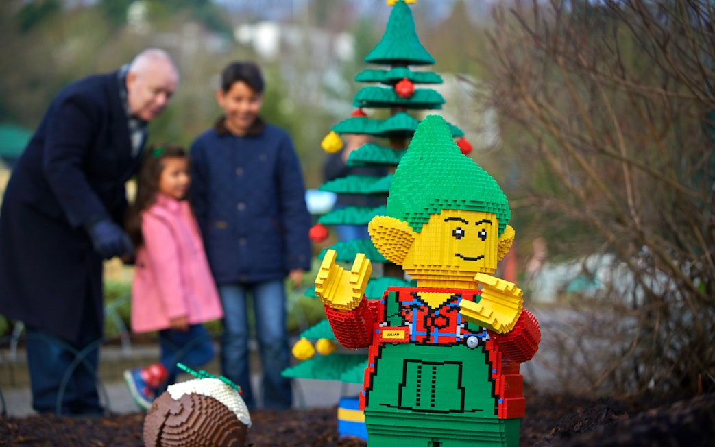 Lego elf sculpture with Christmas tree at Legoland London during holiday season.