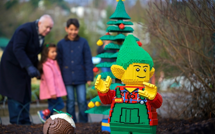 Lego elf sculpture with Christmas tree at Legoland London during holiday season.