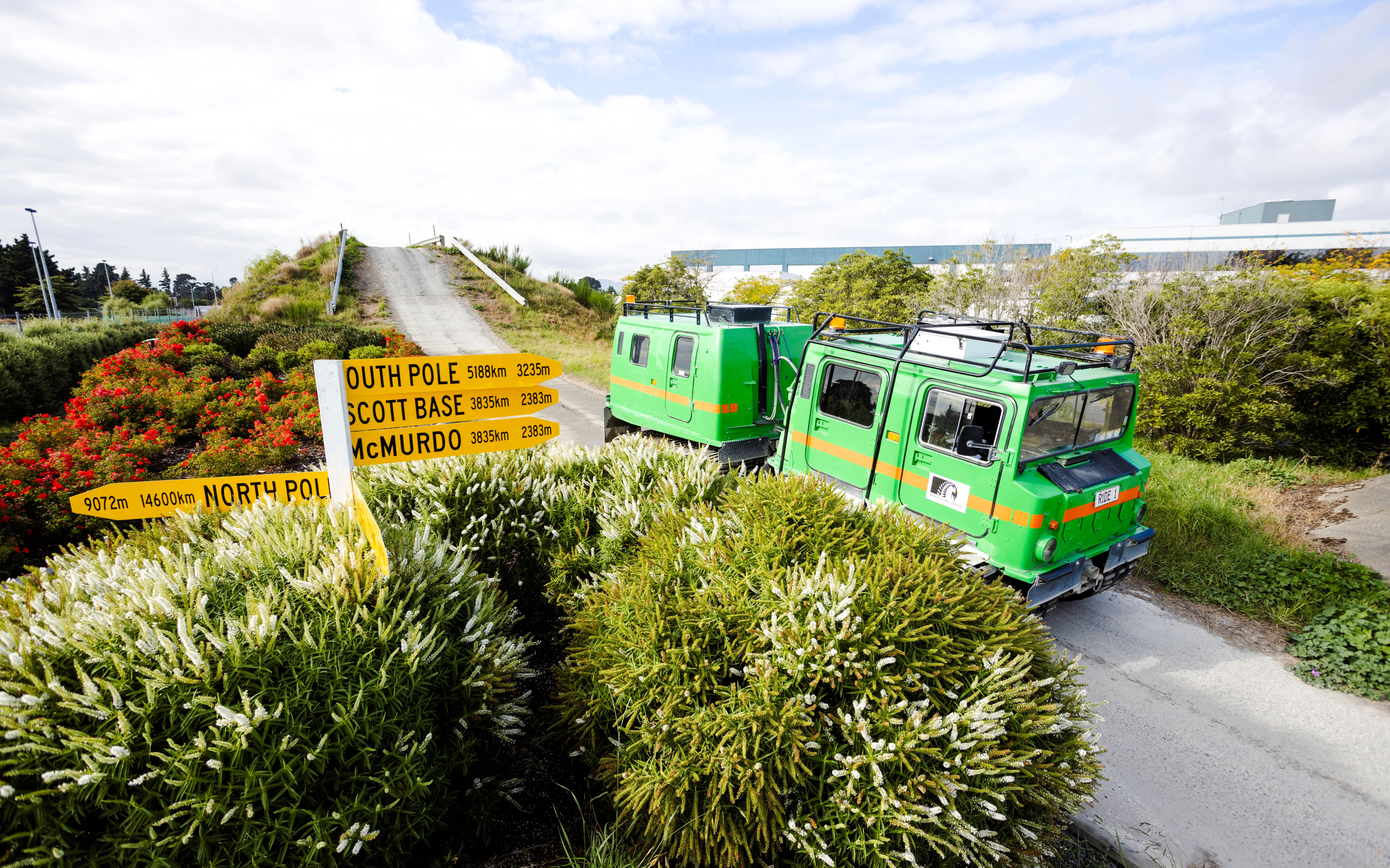 Hägglund vehicle on a track at the International Antarctic Centre, Christchurch, with directional signs.
