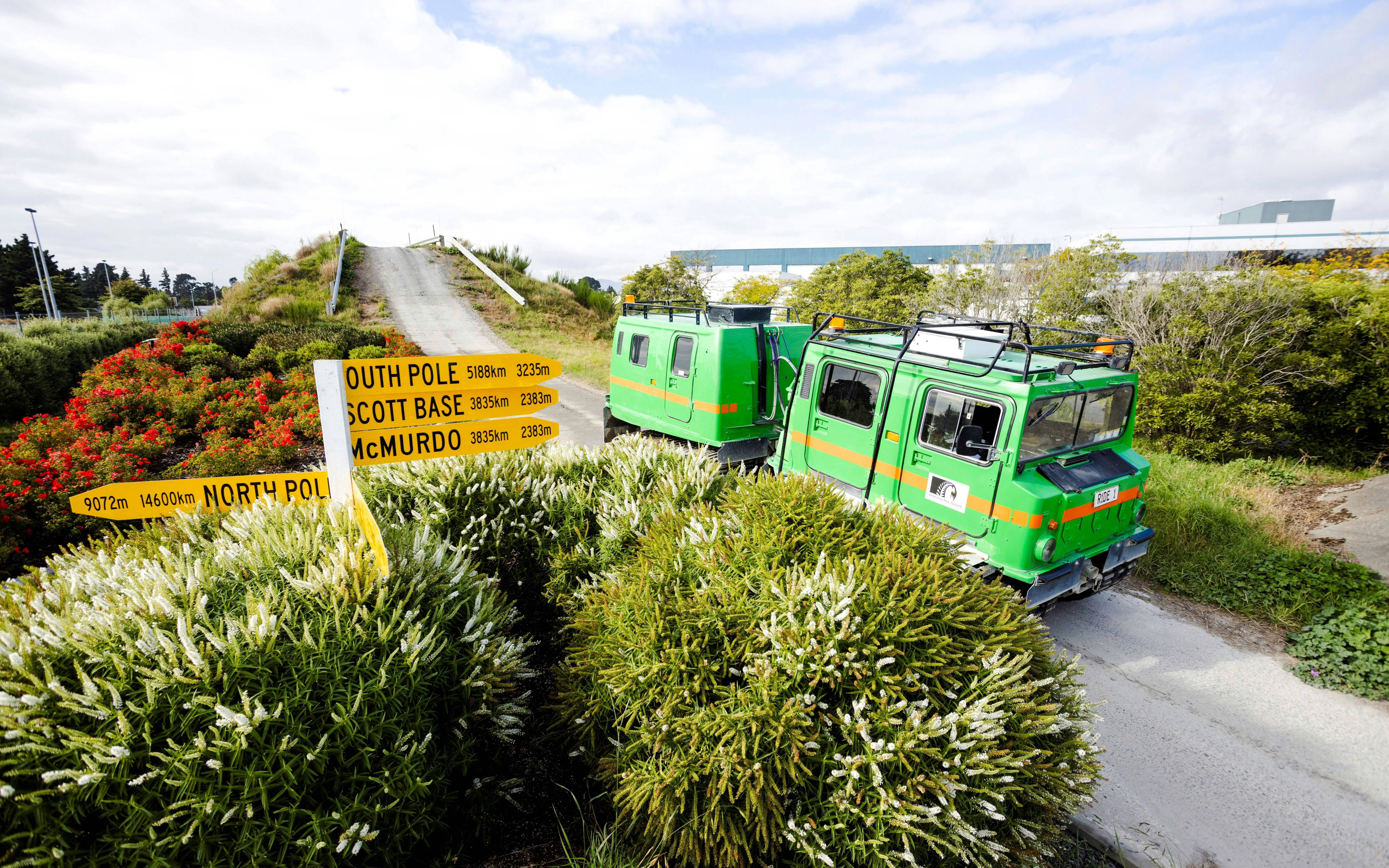 Hägglund vehicle on a track at the International Antarctic Centre, Christchurch, with directional signs.