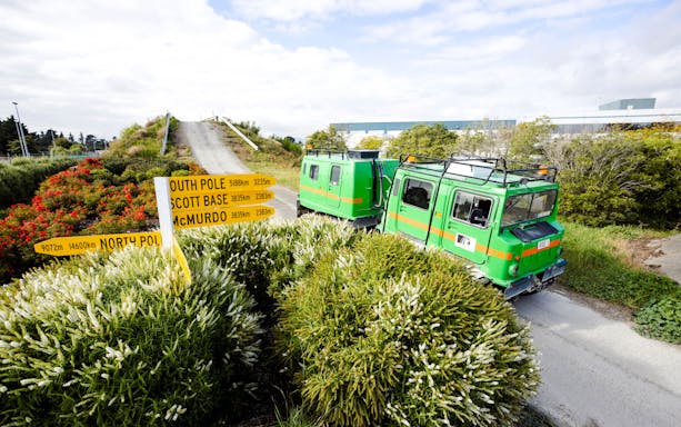 Hägglund vehicle on a track at the International Antarctic Centre, Christchurch, with directional signs.