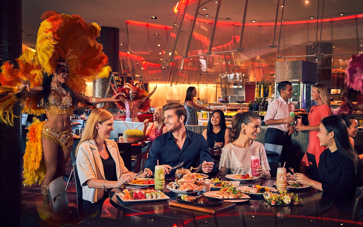 Dinner buffet at Atlantis the Palm with guests enjoying food and entertainment near Ambassador Lagoon Aquarium.
