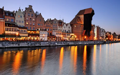 Old Town waterfront at sunset during Shipyard and Old Town Evening Cruise in Gdańsk, Poland.