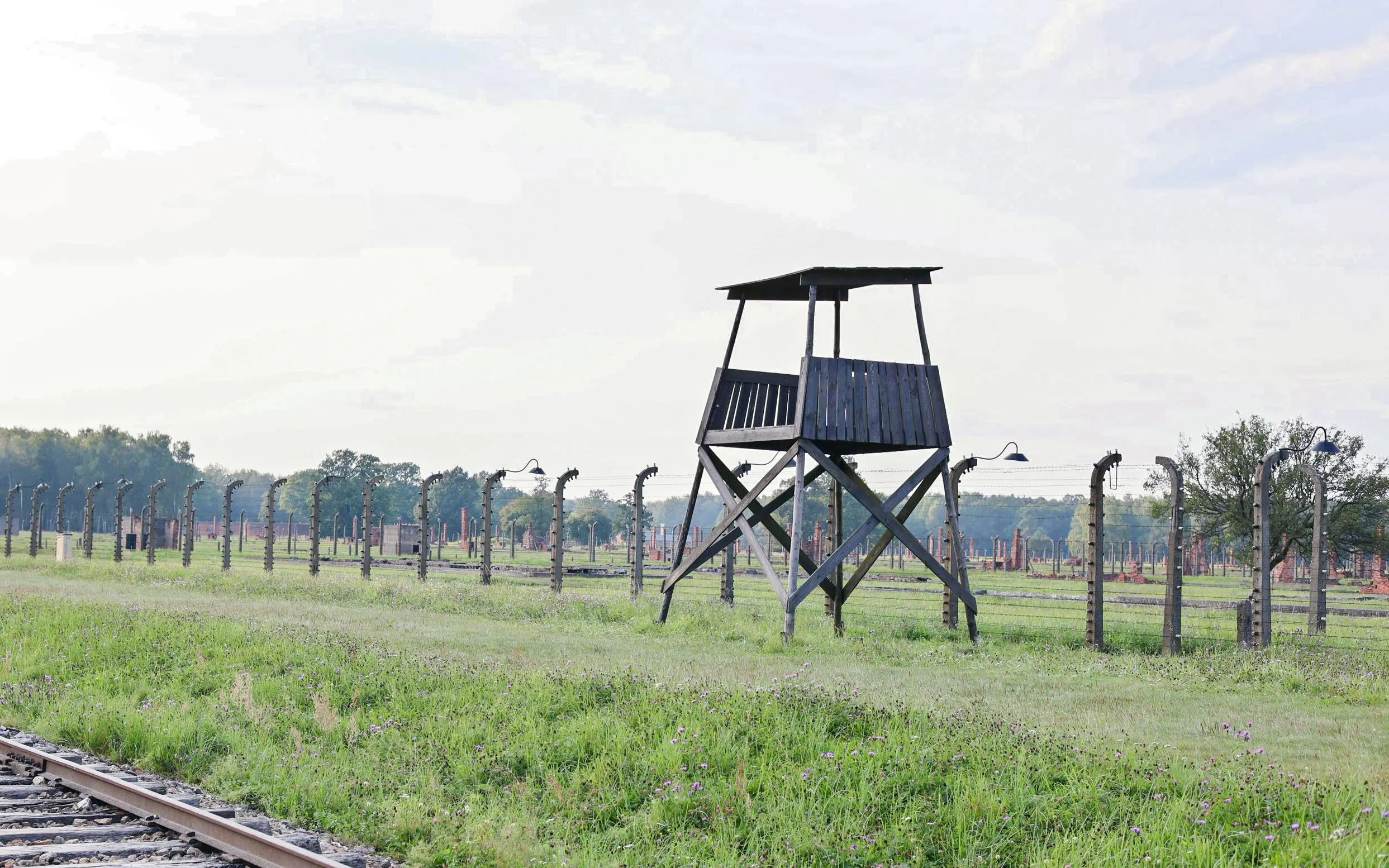 Guard tower and barbed wire fence at Auschwitz-Birkenau, Krakow guided tour.