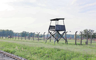 Guard tower and barbed wire fence at Auschwitz-Birkenau, Krakow guided tour.