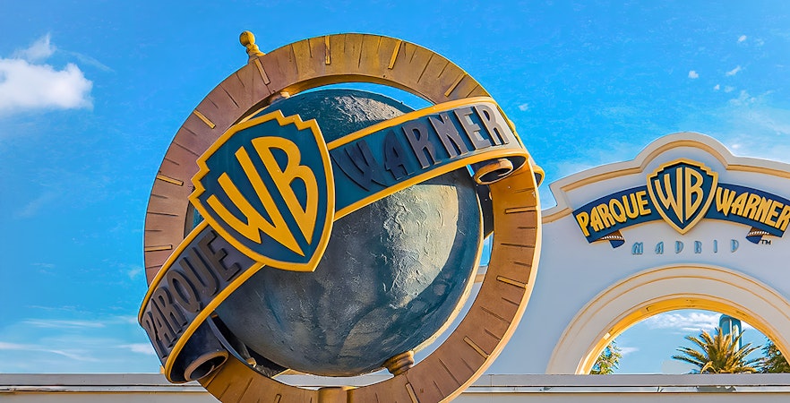 Parque Warner entrance with iconic cartoon character statues in Madrid, Spain.