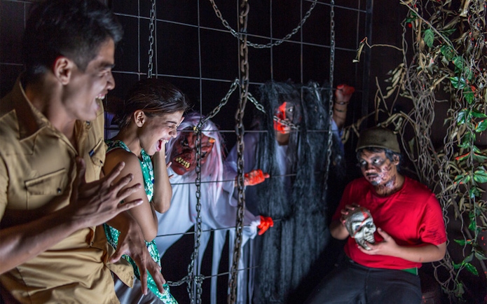 Visitors experiencing a haunted attraction at Sunway Lost World of Tambun, Malaysia.