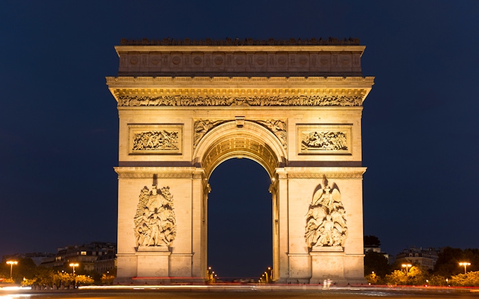 Arc de Triomphe illuminated at night, Paris Hop-On Hop-Off Bus Tour.