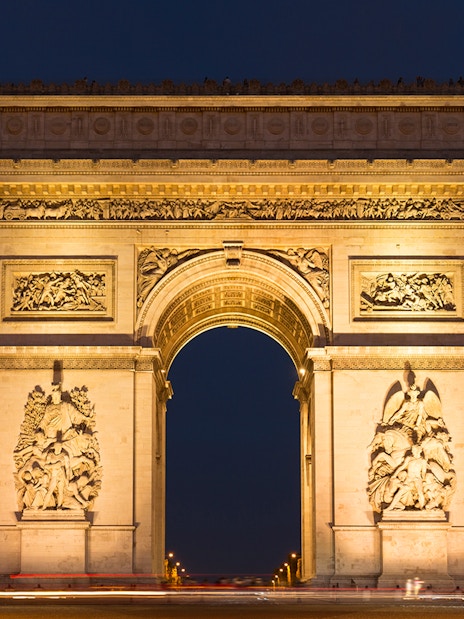 Arc de Triomphe illuminated at night, Paris Hop-On Hop-Off Bus Tour.
