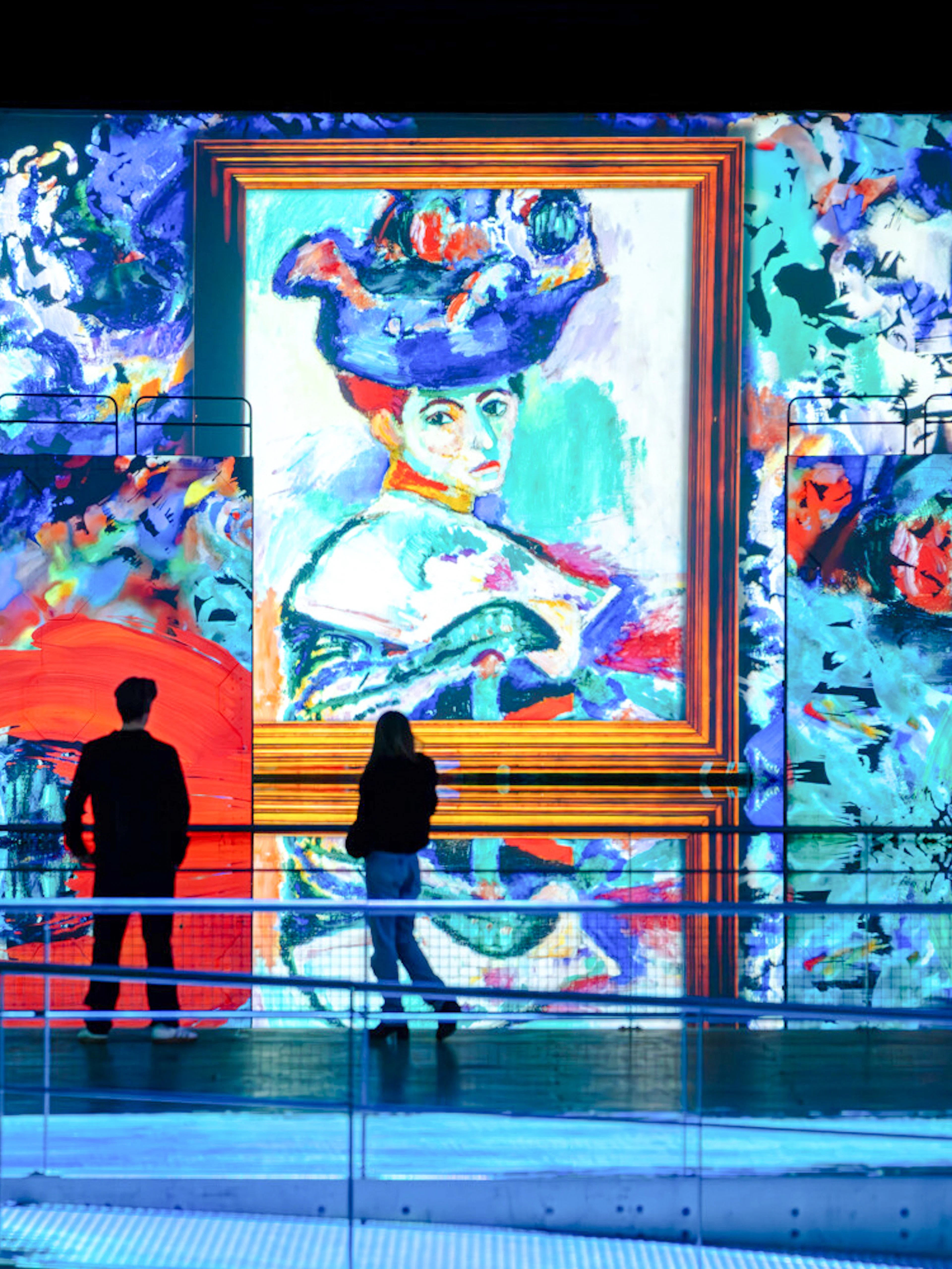 Visitors viewing Matisse artwork projection at Bassins Des Lumieres exhibition.