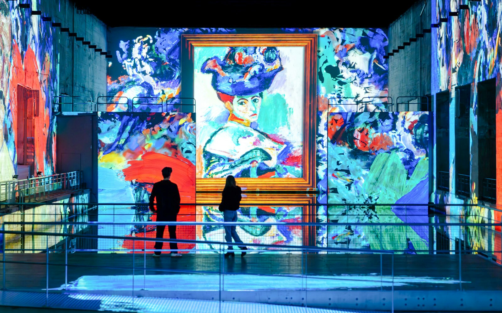 Visitors viewing Matisse artwork projection at Bassins Des Lumieres exhibition.