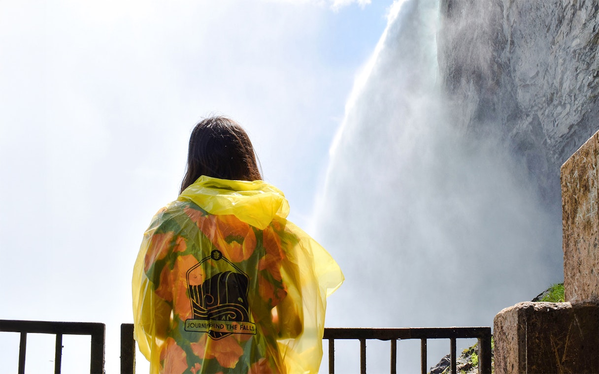 Woman in yellow poncho at Journey Behind the Falls, Niagara Falls.