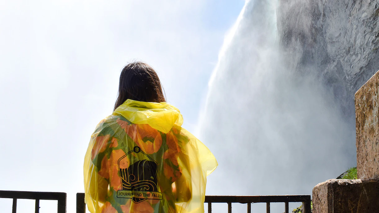 Woman in yellow poncho at Journey Behind the Falls, Niagara Falls.