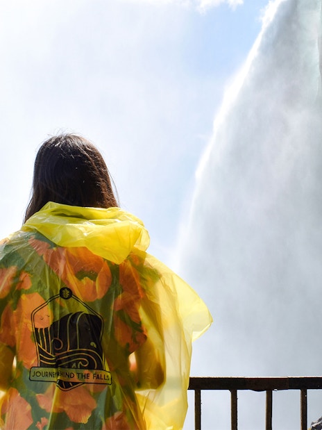 Woman in yellow poncho at Journey Behind the Falls, Niagara Falls.