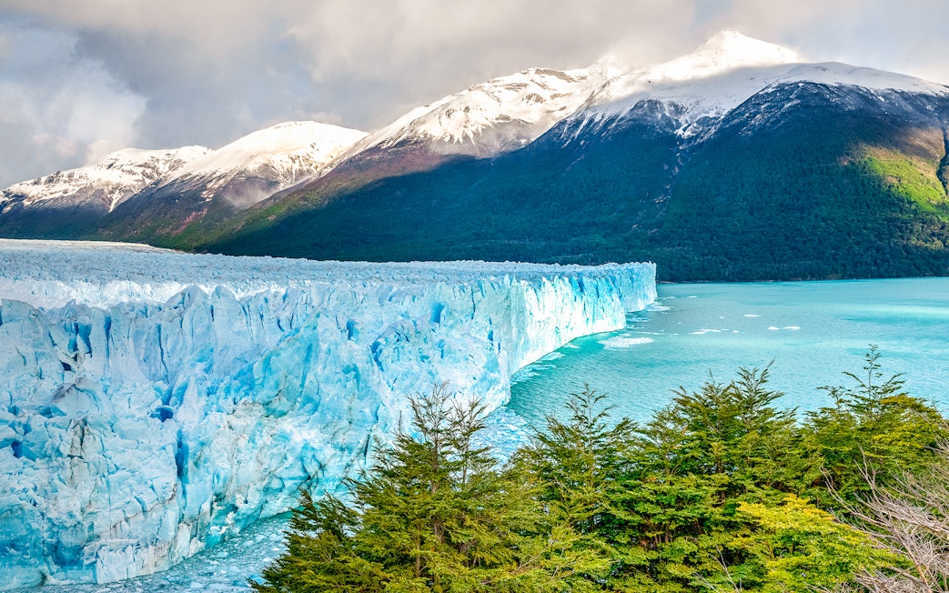 Perito Moreno Glacier with snow-capped mountains and turquoise lake in Patagonia, Argentina.