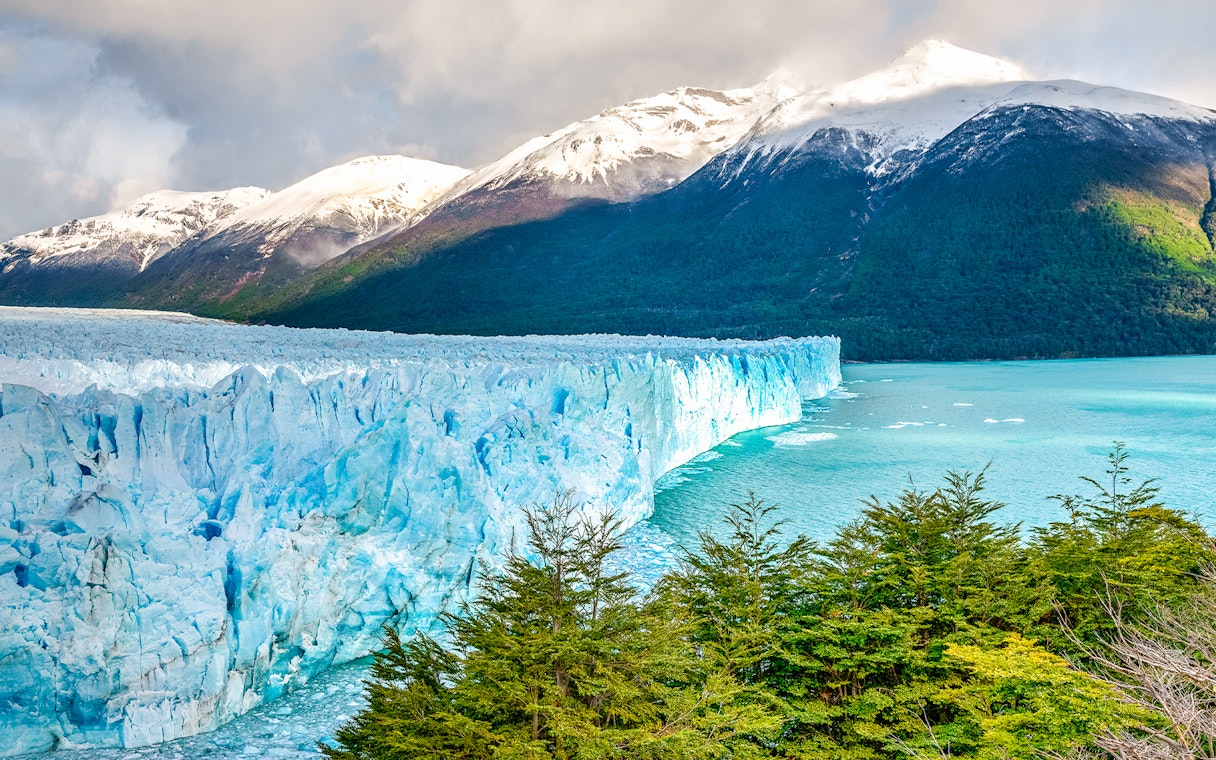 Perito Moreno Glacier with snow-capped mountains and turquoise lake in Patagonia, Argentina.
