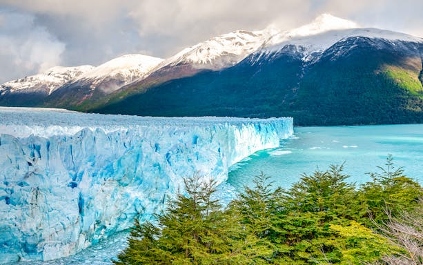 Perito Moreno Glacier with snow-capped mountains and turquoise lake in Patagonia, Argentina.