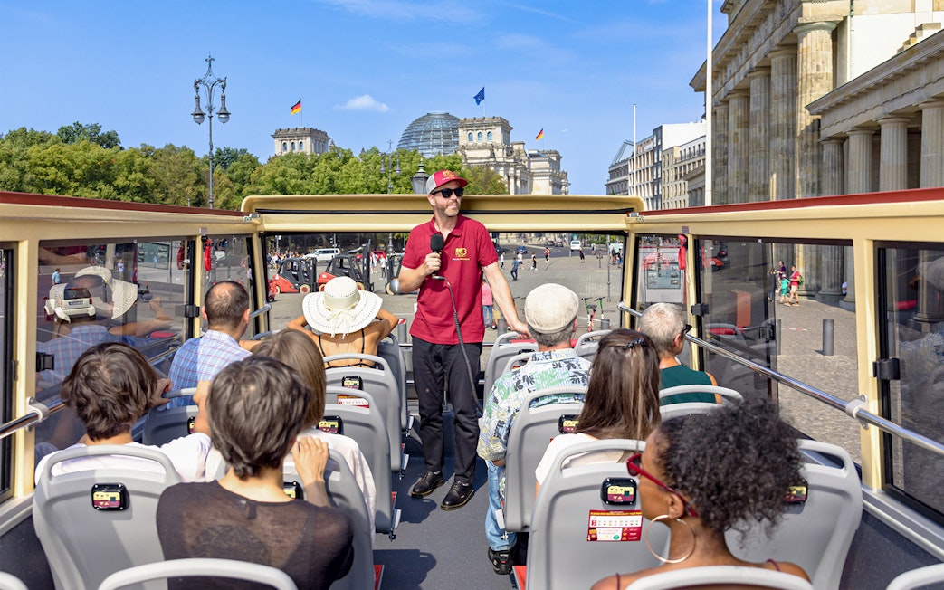 Participants on a Big Bus Berlin tour listen to a guide near the Reichstag building.