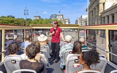 Participants on a Big Bus Berlin tour listen to a guide near the Reichstag building.