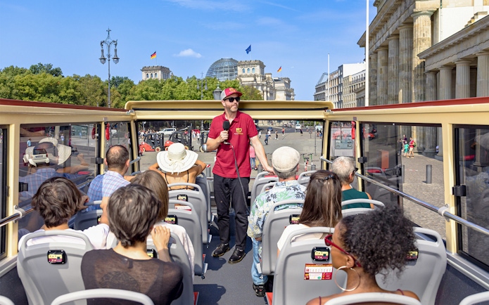 Participants on a Big Bus Berlin tour listen to a guide near the Reichstag building.