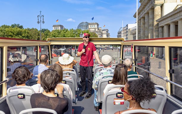 Participants on a Big Bus Berlin tour listen to a guide near the Reichstag building.